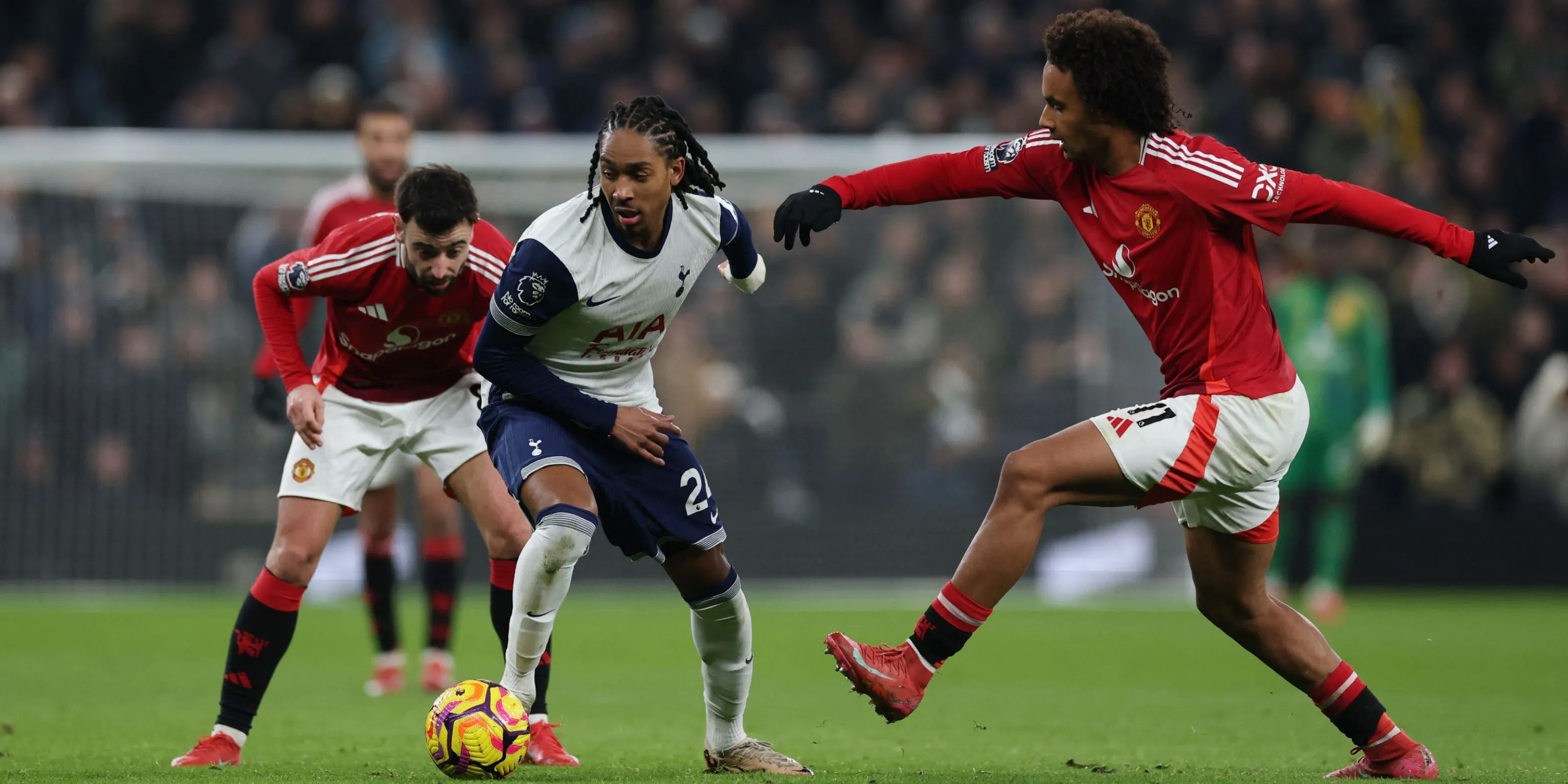 Djed Spence của Tottenham tranh chấp bóng với cầu thủ Manchester United trong một trận đấu tại Premier League